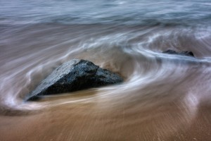 water flowing around a rock